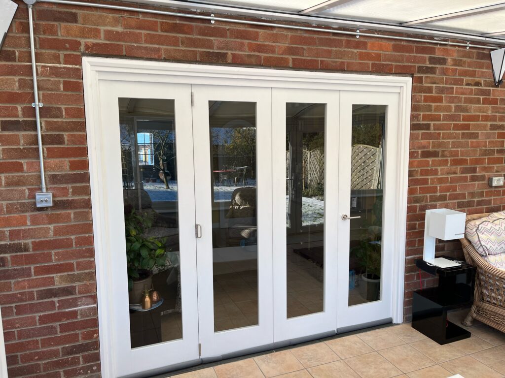 A customer image of a four panel white bifold door.
